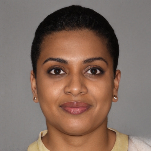 Joyful black young-adult female with short  brown hair and brown eyes
