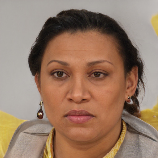 Joyful latino adult female with short  brown hair and brown eyes