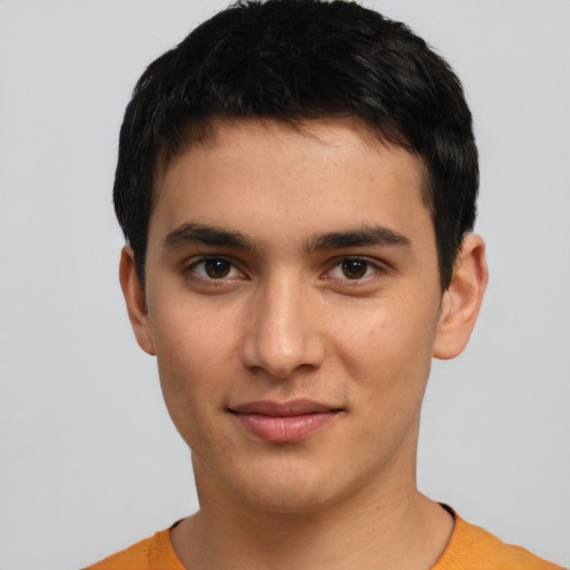 Joyful white young-adult male with short  black hair and brown eyes