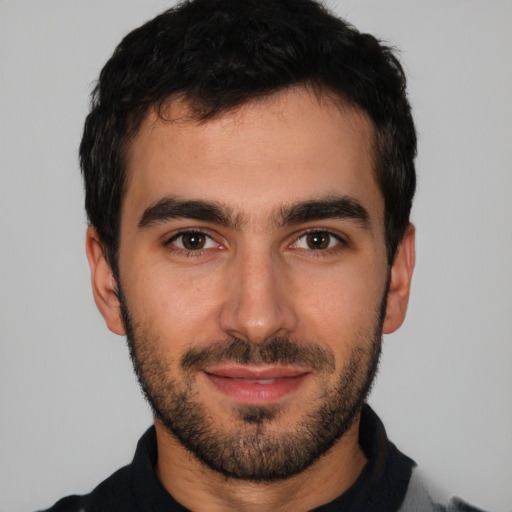 Joyful white young-adult male with short  black hair and brown eyes