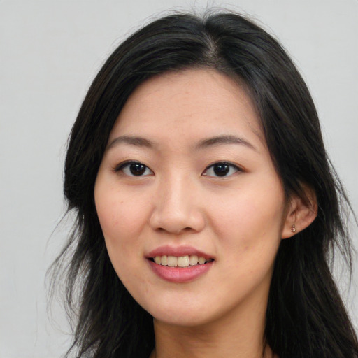 Joyful white young-adult female with long  black hair and brown eyes