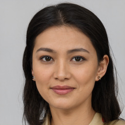 Joyful latino young-adult female with long  brown hair and brown eyes