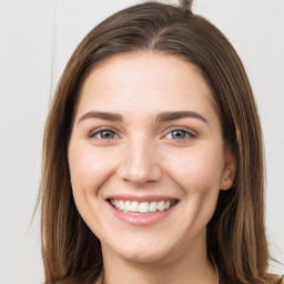 Joyful white young-adult female with long  brown hair and grey eyes