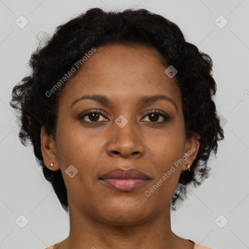 Joyful black adult female with short  brown hair and brown eyes