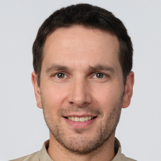 Joyful white young-adult male with short  brown hair and brown eyes