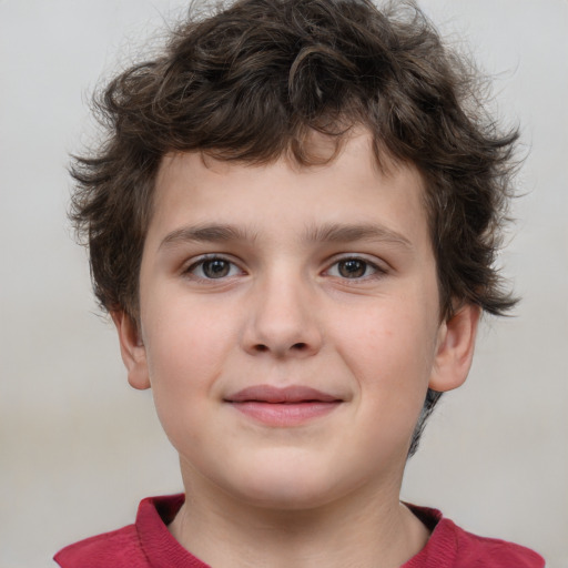 Joyful white child male with short  brown hair and grey eyes