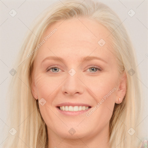 Joyful white young-adult female with long  blond hair and blue eyes