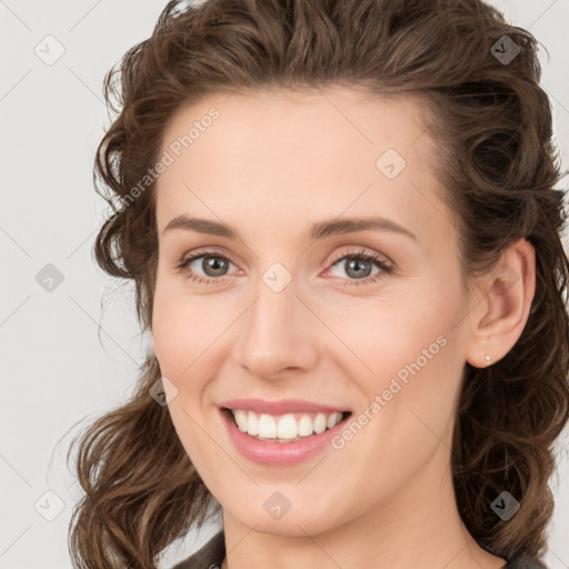 Joyful white young-adult female with medium  brown hair and green eyes