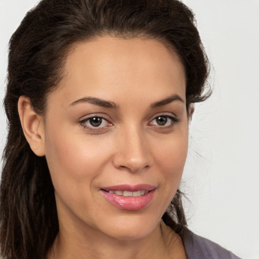 Joyful white young-adult female with long  brown hair and brown eyes