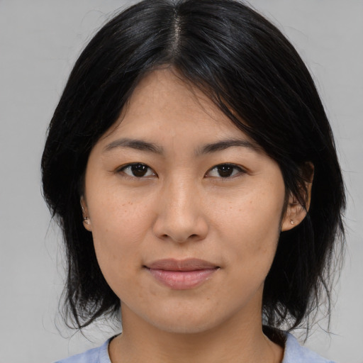 Joyful asian young-adult female with medium  black hair and brown eyes