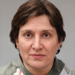 Joyful white adult female with medium  brown hair and blue eyes