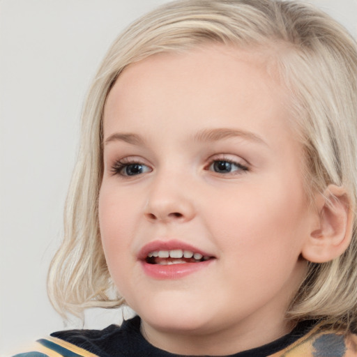 Joyful white child female with medium  brown hair and blue eyes