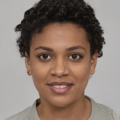 Joyful black young-adult female with short  brown hair and brown eyes