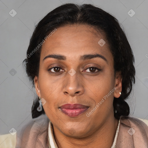 Joyful latino adult female with medium  brown hair and brown eyes