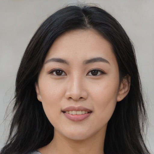 Joyful asian young-adult female with long  black hair and brown eyes