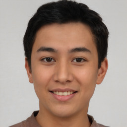 Joyful asian young-adult male with short  brown hair and brown eyes