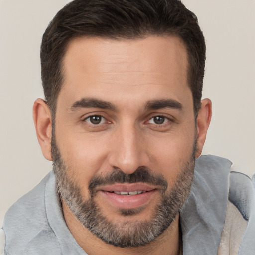 Joyful white adult male with short  brown hair and brown eyes