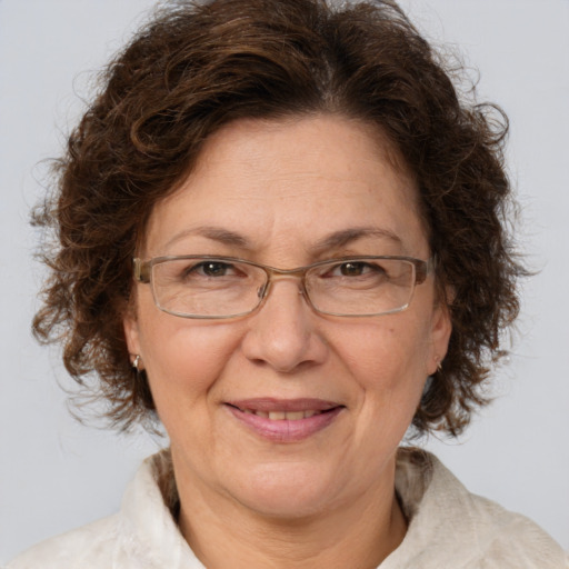 Joyful white middle-aged female with medium  brown hair and brown eyes