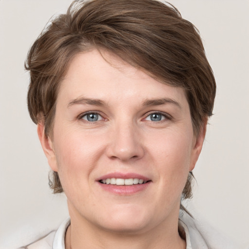 Joyful white young-adult female with medium  brown hair and grey eyes