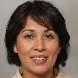 Joyful white adult female with medium  brown hair and brown eyes