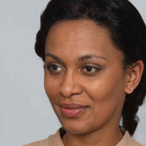 Joyful black adult female with short  brown hair and brown eyes
