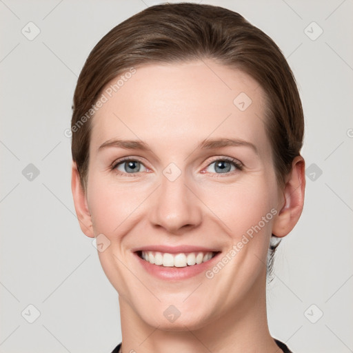 Joyful white young-adult female with short  brown hair and grey eyes