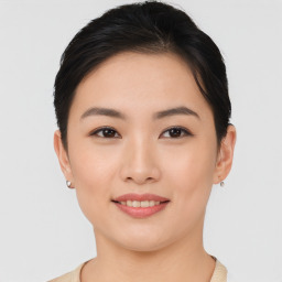 Joyful asian young-adult female with short  brown hair and brown eyes