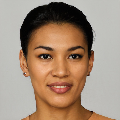 Joyful latino young-adult female with short  black hair and brown eyes