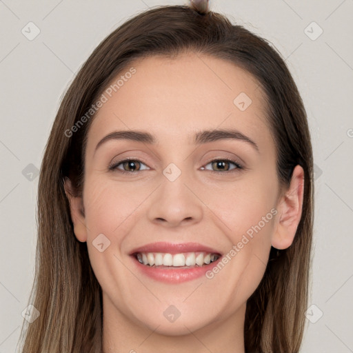 Joyful white young-adult female with long  brown hair and grey eyes