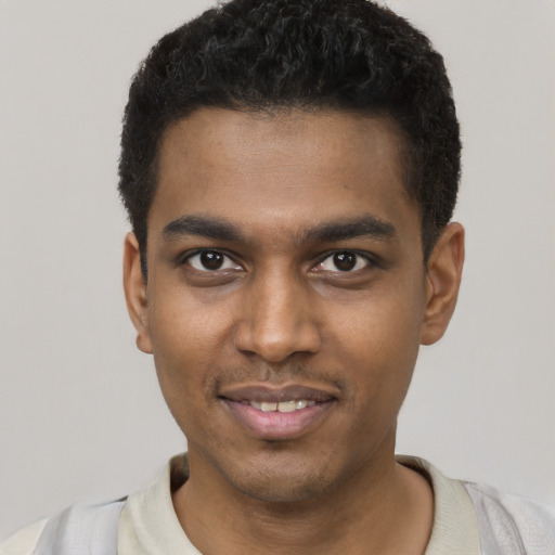 Joyful black young-adult male with short  brown hair and brown eyes