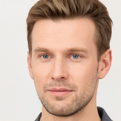 Joyful white young-adult male with short  brown hair and brown eyes