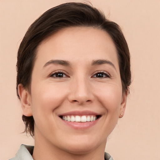 Joyful white young-adult female with short  brown hair and brown eyes