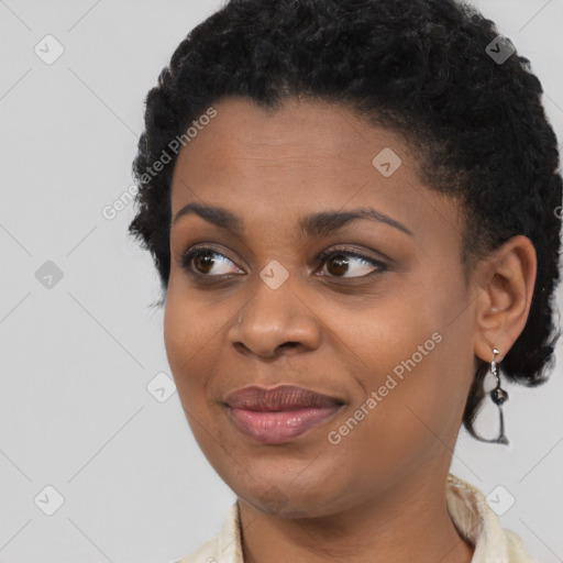 Joyful black young-adult female with short  black hair and brown eyes