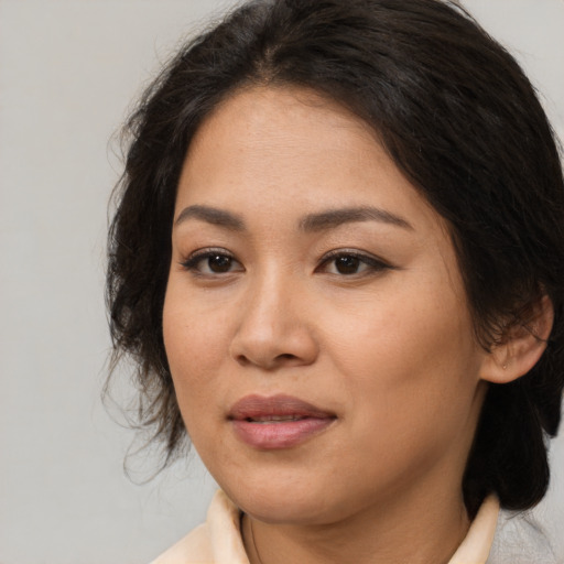Joyful asian young-adult female with medium  brown hair and brown eyes