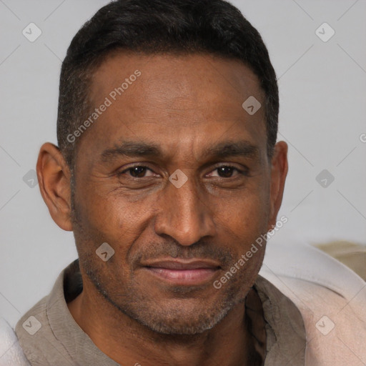 Joyful black adult male with short  brown hair and brown eyes