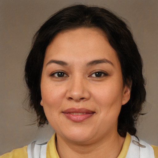 Joyful latino adult female with medium  brown hair and brown eyes