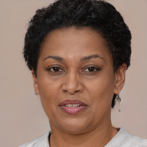 Joyful black adult female with short  brown hair and brown eyes