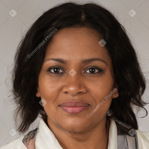 Joyful black adult female with medium  brown hair and brown eyes