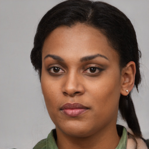 Joyful black young-adult female with medium  black hair and brown eyes