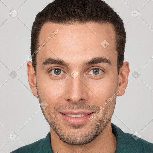 Joyful white young-adult male with short  brown hair and brown eyes