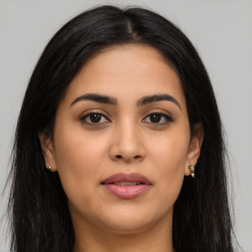 Joyful latino young-adult female with long  black hair and brown eyes