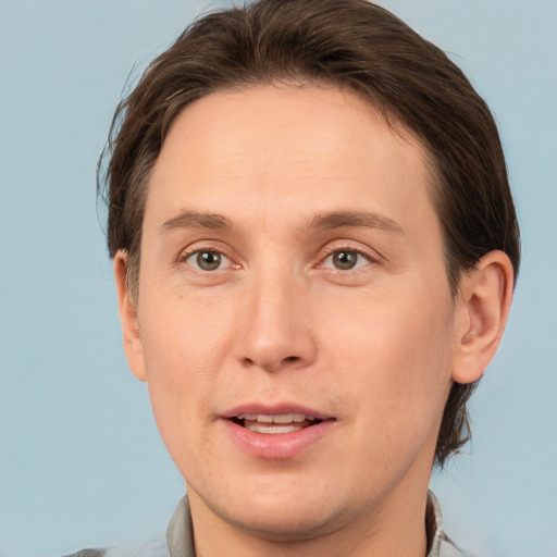 Joyful white adult male with short  brown hair and brown eyes