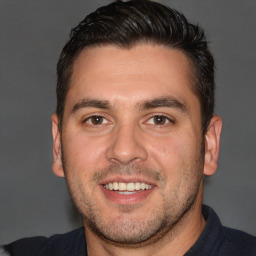 Joyful white adult male with short  brown hair and brown eyes