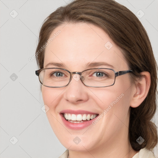 Joyful white adult female with medium  brown hair and blue eyes