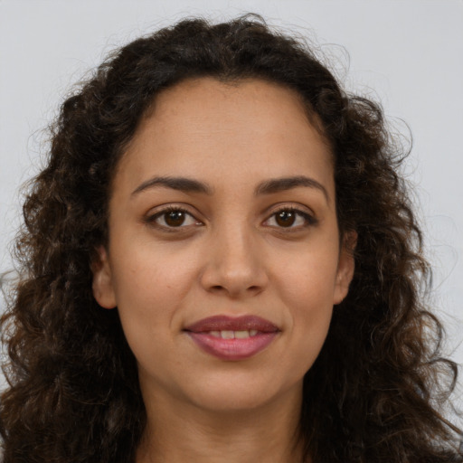 Joyful latino young-adult female with long  brown hair and brown eyes