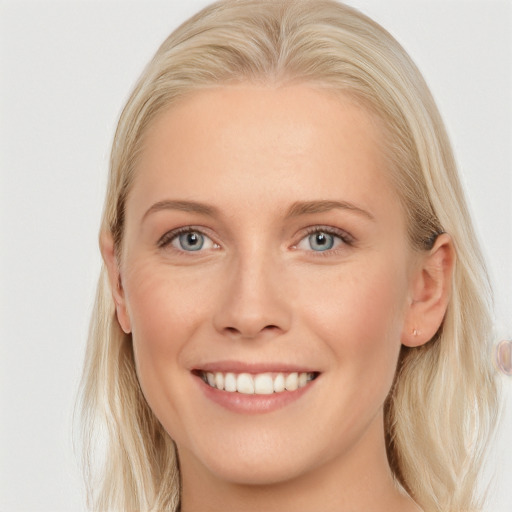 Joyful white young-adult female with long  blond hair and blue eyes