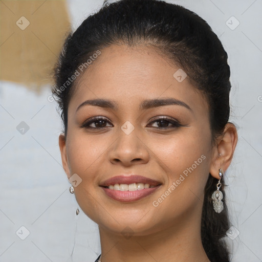 Joyful latino young-adult female with long  brown hair and brown eyes