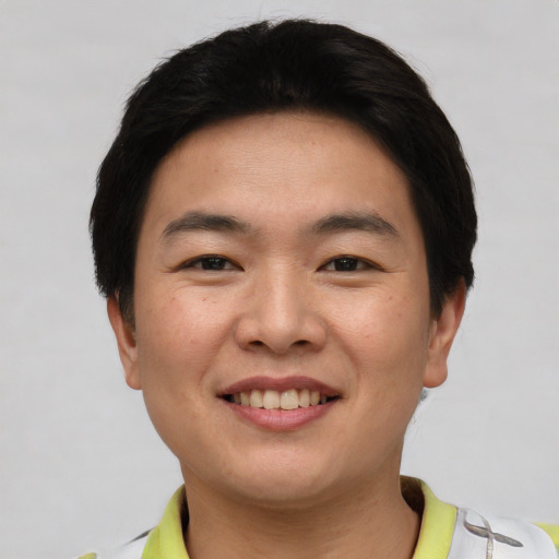 Joyful asian young-adult male with short  black hair and brown eyes