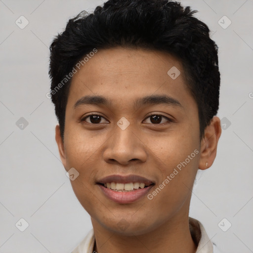 Joyful latino young-adult male with short  black hair and brown eyes