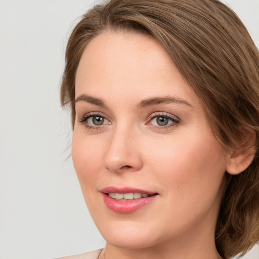 Joyful white young-adult female with medium  brown hair and blue eyes